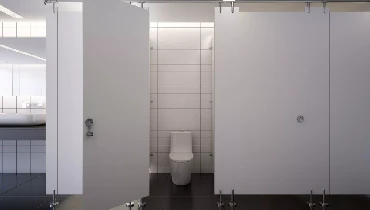 A standard toilet in a bathroom stall located inside of a office building.