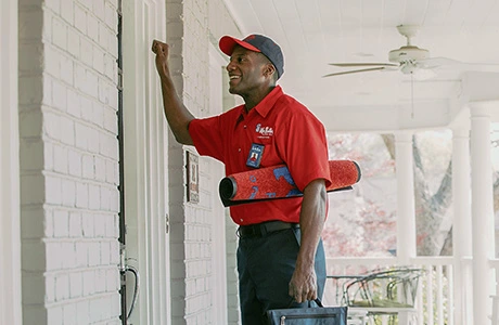 Mr. Rooter plumber knocking on a door