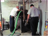 Plumbers Cleaning a Grease Trap
