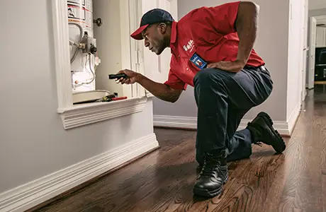 Mr. Rooter plumber fixing water heater