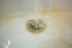Water pouring into a clogged tub in need of plumbers in Vineland, NJ