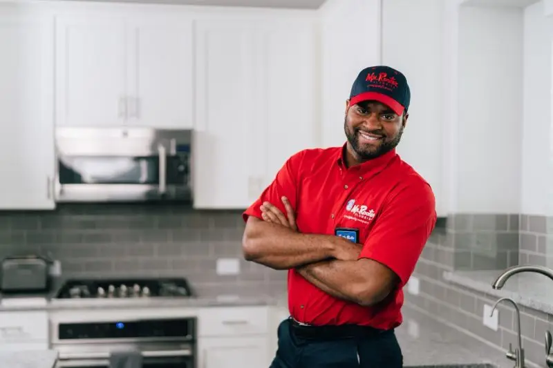 : Mr. Rooter plumber ready to repair heating system