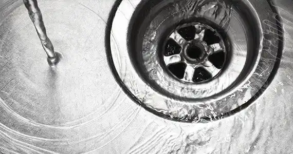 water pouring down a drain that was just cleaned