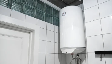 An image of a water heater attached to a wall in a home.
