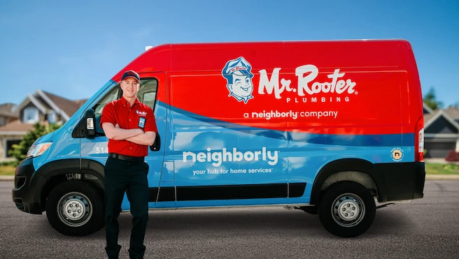 A smiling plumber in a red 