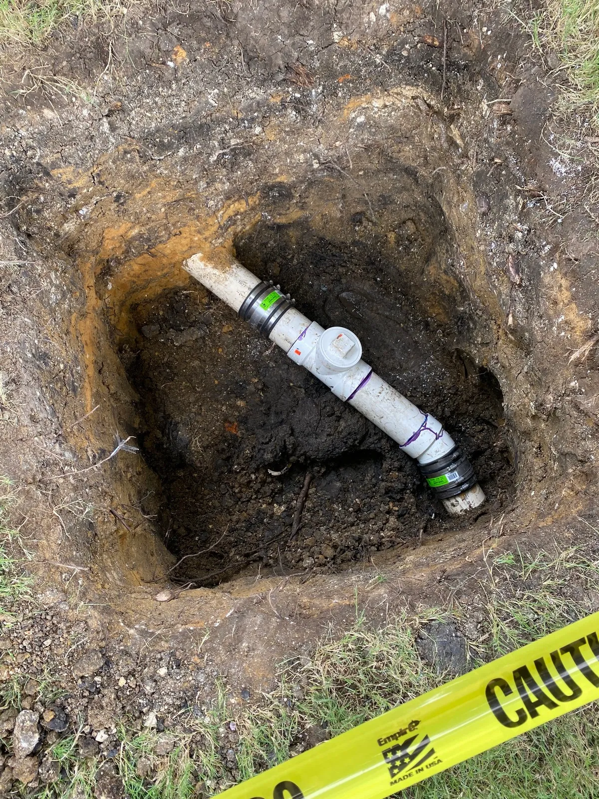 Exposed Dallas sewer line about to be repaired by Mr. Rooter Plumbing. 