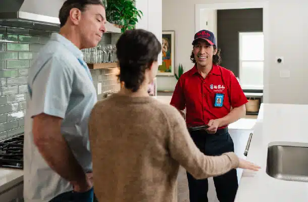 A Mr. Rooter professional discussing services with customers