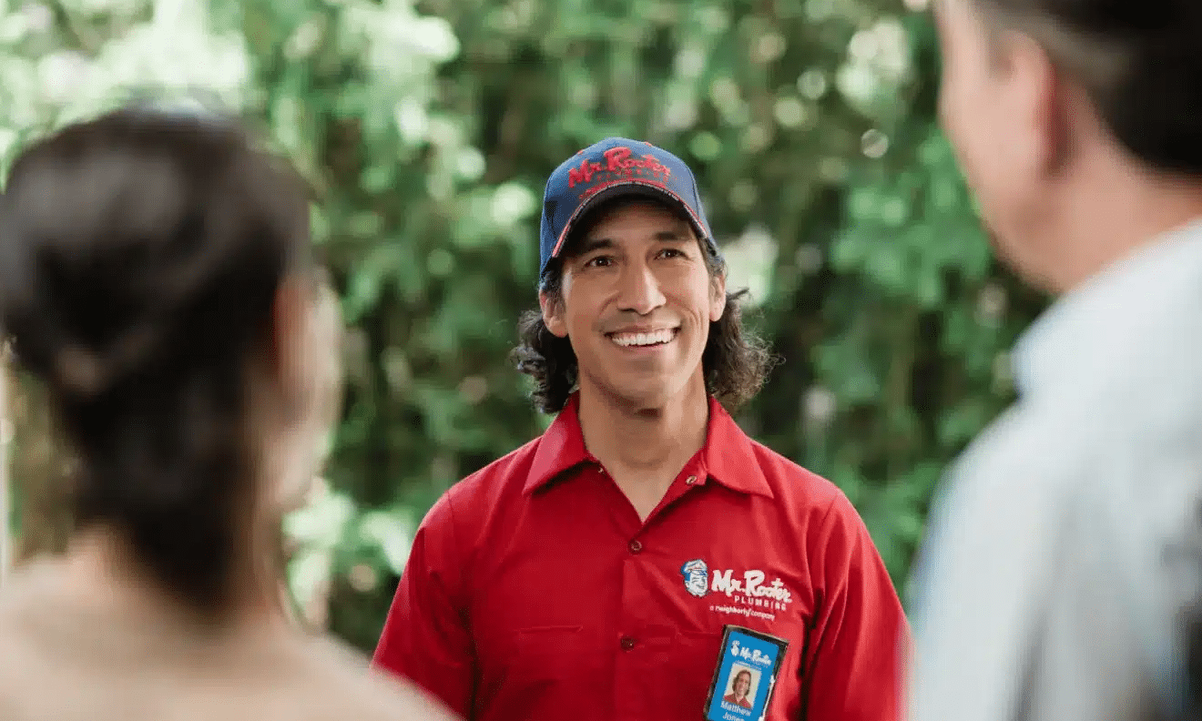 A Mr. Rooter professional greeting customers