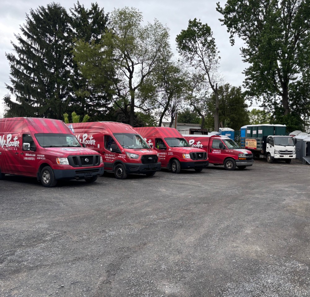 Red Mr. Rooter Plumbing Vans in a line.