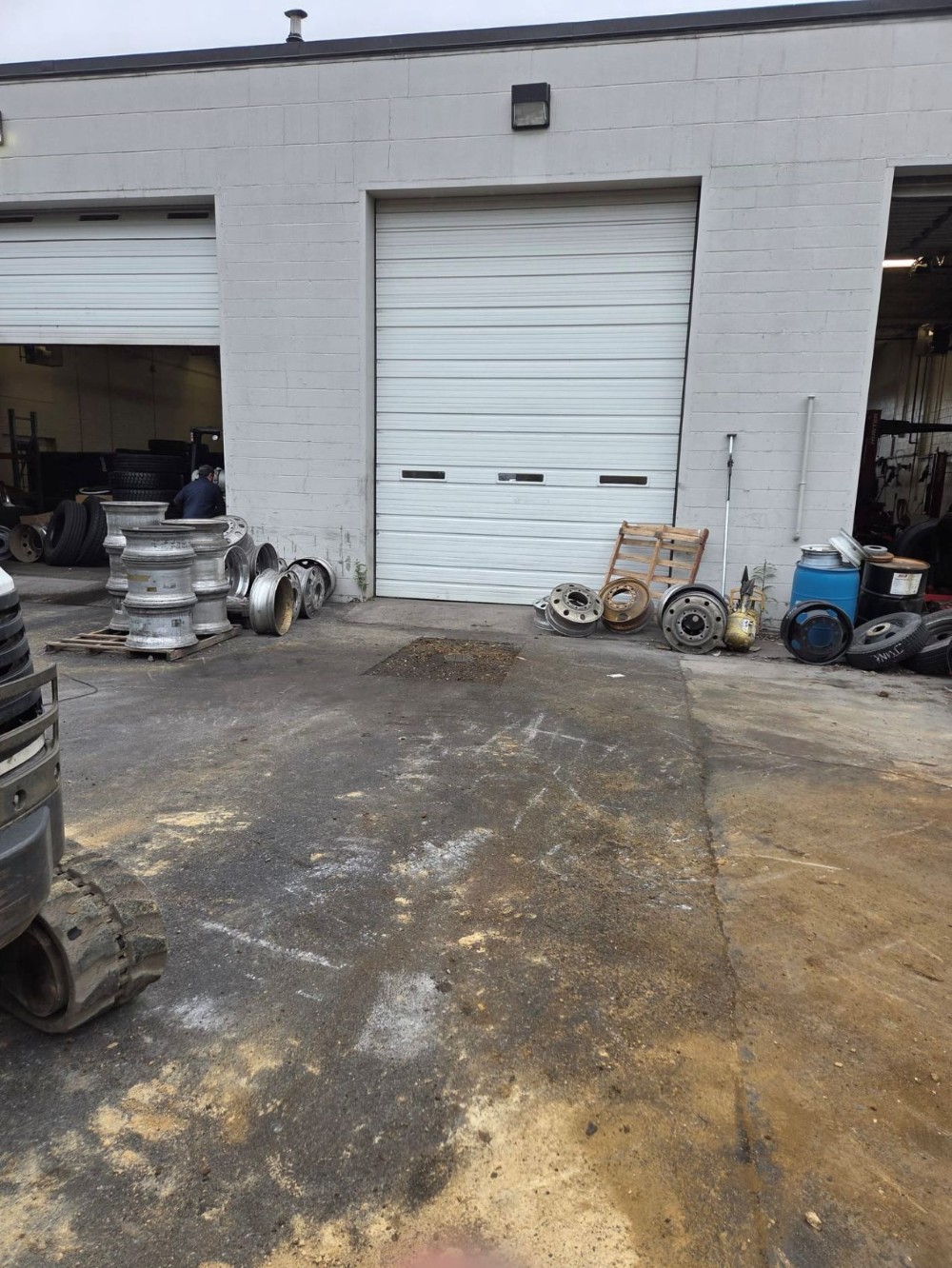 white garage with new asphalt and sewer clean out
