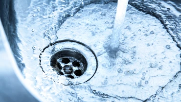 Clean water flows freely down the drain in an aluminum sink. | Mr. Rooter® Plumbing of The Oakland-Berkeley Area
