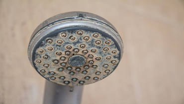 Hard water calcium deposit and corrosion on chrome shower tap | Mr. Rooter Plumbing of Memphis