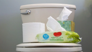 Things piled up on the toilet seat