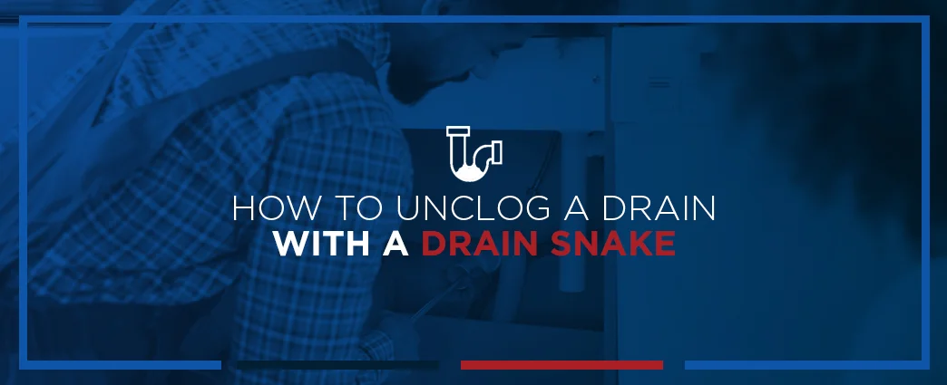 Plumber using drain snake with text: How to unclog a drain with a drain snake