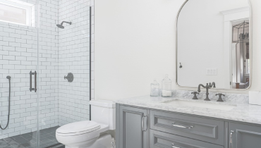 A contemporary, recently remodeled white and gray bathroom.