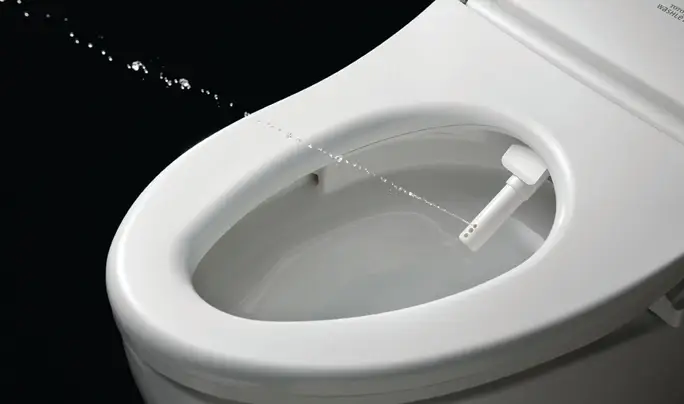 A bidet for a TOTO toilet.