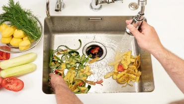 Food waste after peeling vegetables is destroyed using the disposal | Mr. Rooter Plumbing