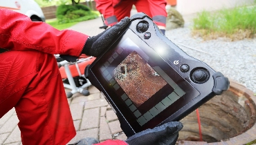 A sewer line video inspection tablet with live feed from a sewer line
