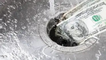 Money going down a running sink drain