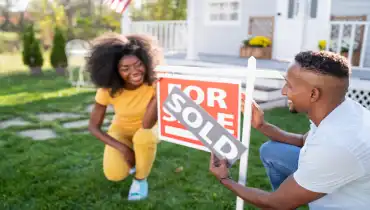 Young black couple in front of sold sign | Mr. Rooter Plumbing of South Jersey
