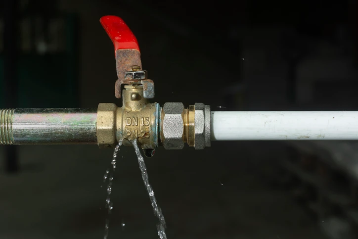 A valve connecting two pipes is leaking water. | Mr. Rooter Plumbing of Wilmington and Brunswick County
