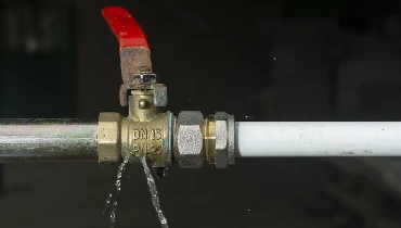 A valve connecting two pipes is leaking water. | Mr. Rooter Plumbing of Wilmington and Brunswick County