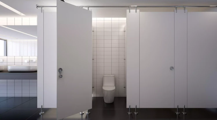 A standard toilet in a bathroom stall located inside of a office building.