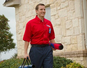 A Mr. Rooter plumber in Waycross, GA walking to a job