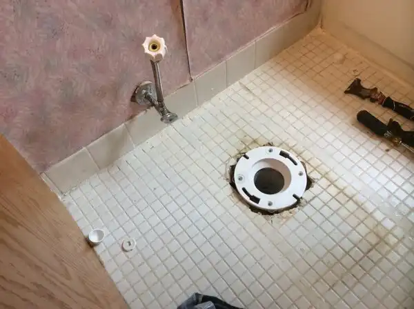 Shower drain in need of repair in Sag Harbor home.
