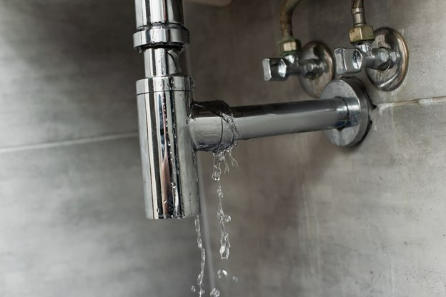 Stainless steel shower faucet leaking water.