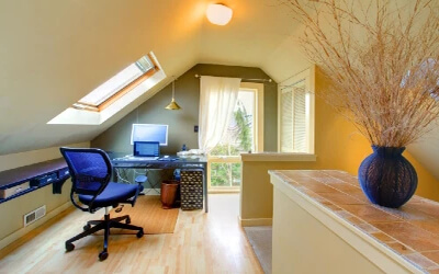 Office room in a home with vaulted ceiling.