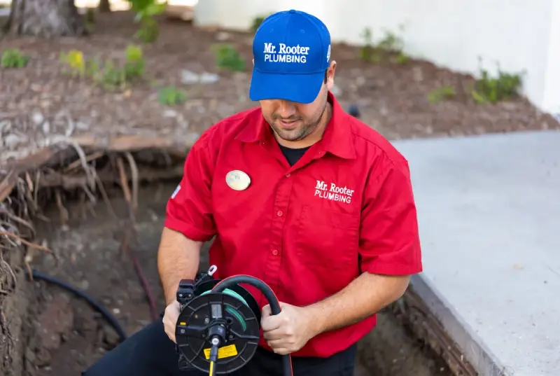 Mr. Rooter professional doing a sewer line repair.