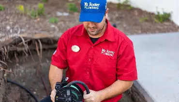 Mr. Rooter professional doing a sewer line repair.