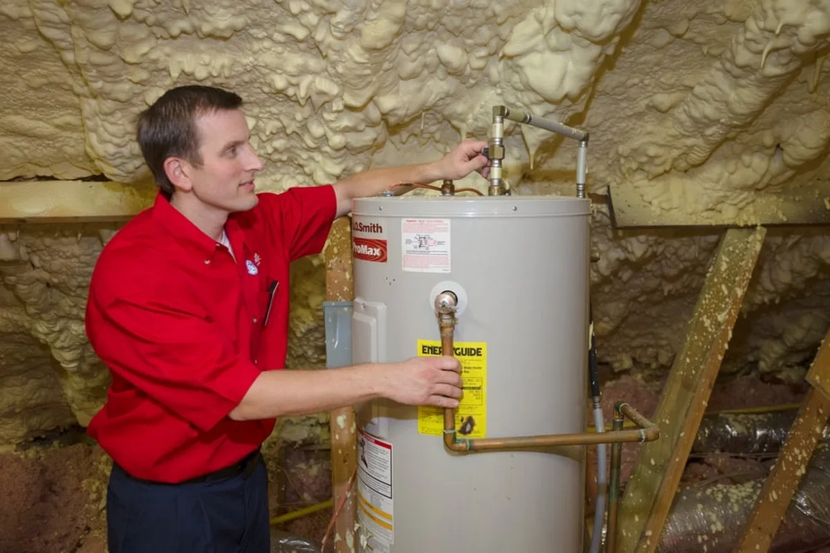 a Mr. Rooter plumber fixing a water heater