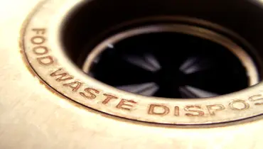garbage disposal drain in sink with an engraving that reads &quot;food waste disposal&quot;