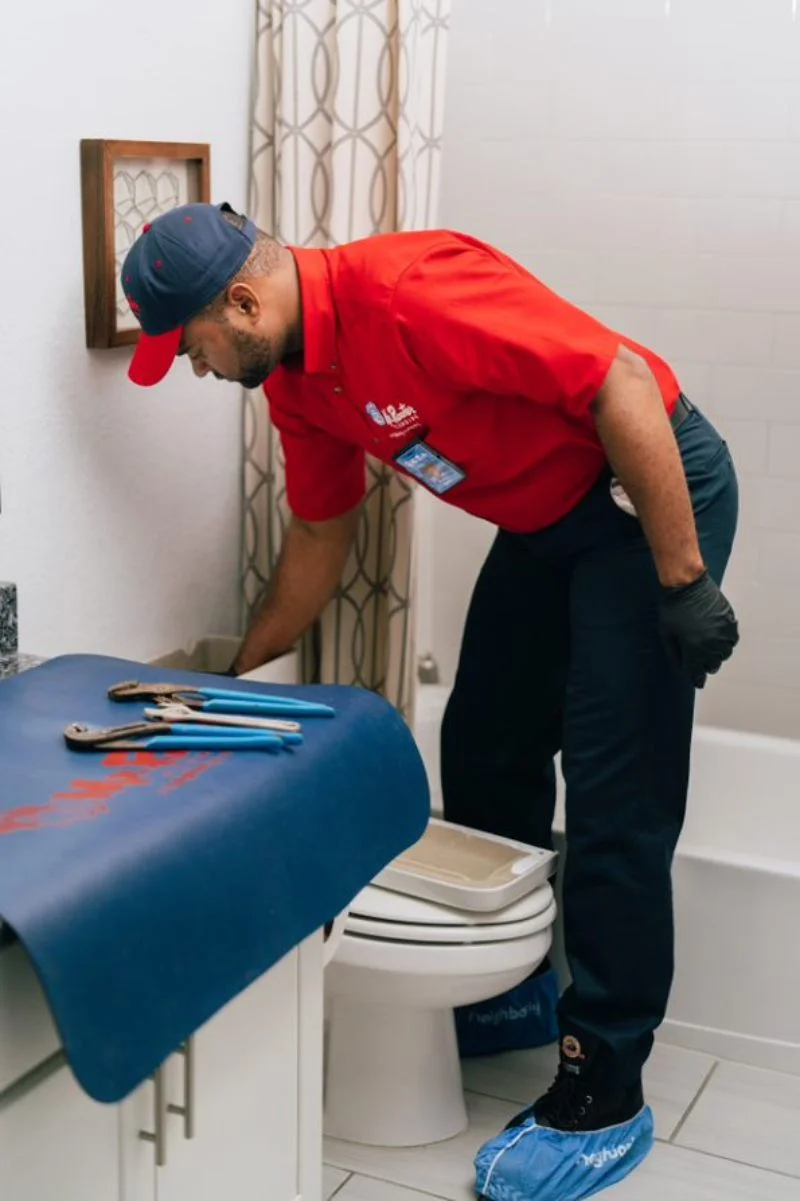 Mr. Rooter plumber performing a toilet repair service in Toledo, OH.