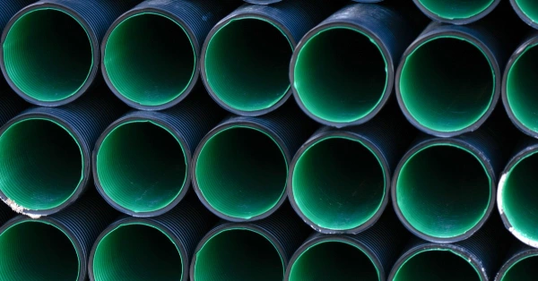 A row of large pipes with bright, plastic linings running through them that have been installed with professional services for pipe lining in San Antonio, TX.