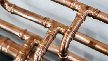 Three lines of copper pipes that are commonly known to experience the problems that result in pipes making noise in Ronkonkoma, NY.