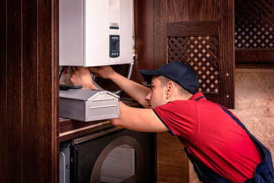 A plumber working on a tankless water heater