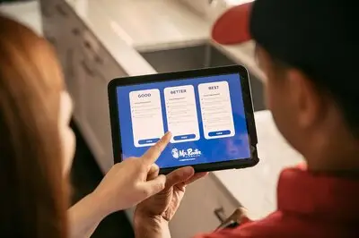 A customer pointing at a "Better" option on a Mr. Rooter plumber's tablet