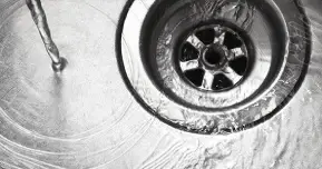 water flowing into sink drain