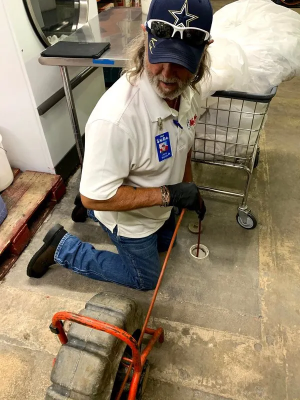 A Mr. Rooter Plumbing technician using specialized equipment for San Antonio drain cleaning.