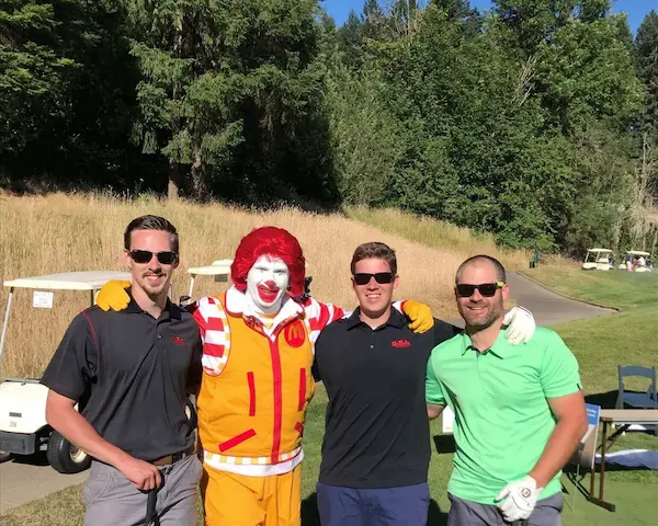 Mr. Rooter Plumbing employees Dillon Anderson, Evan Gilges and Brian Lee, standing for a picture with Ronald McDonald.